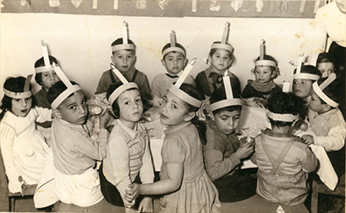 Hanukah in Tehila Kindergarten, Musrara, Varda Amos on the left. 1957